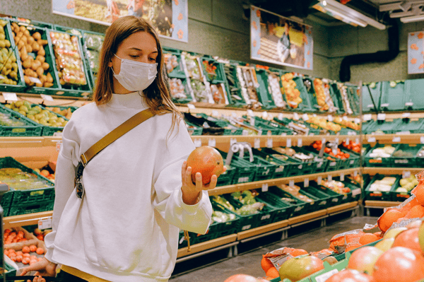 female buying fruits and vegetables on the store