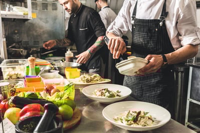 Professional chef cooking in the kitchen restaurant at the hotel, preparing dinner.