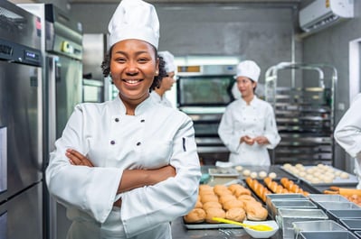 Smiling african female bakers looking at camera