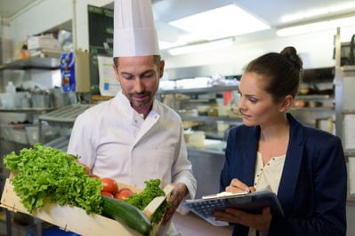 woman undergoing inspection in restaurant kitchen