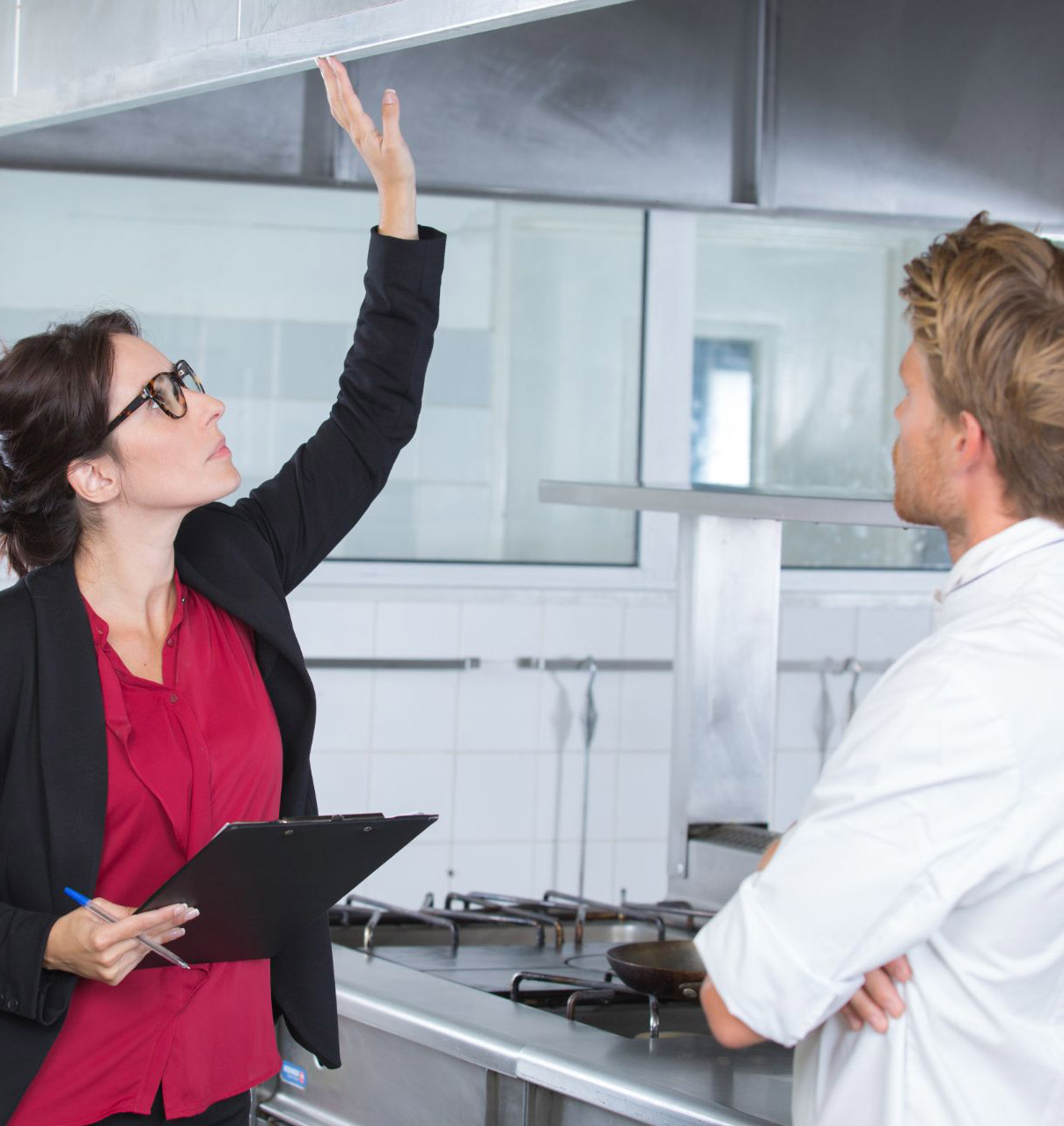 woman inspecting restaurant kitchen