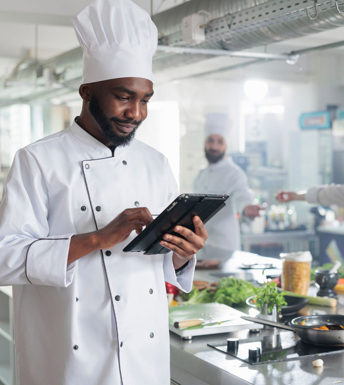 chef in kitchen with tablet