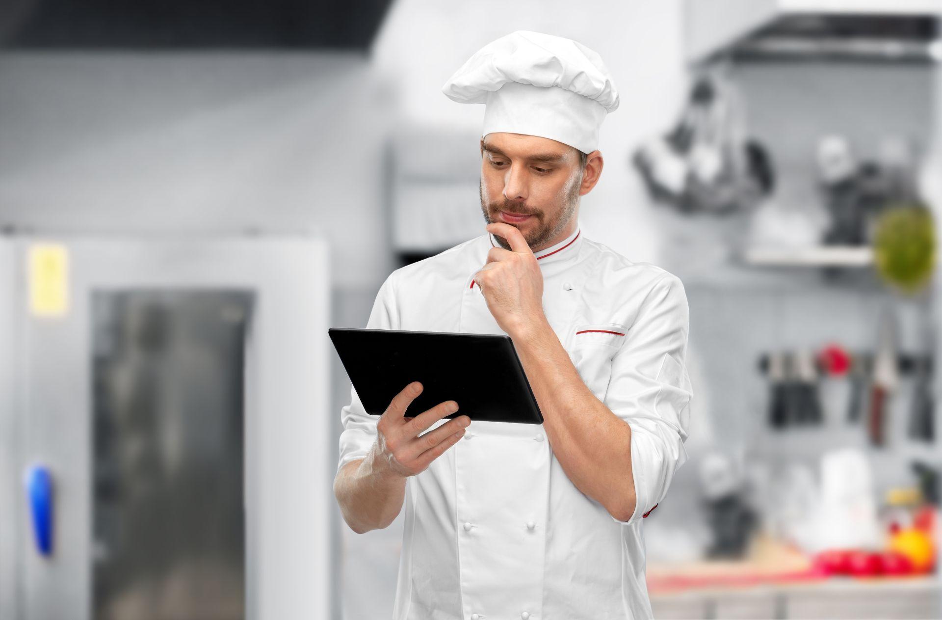 chef looking at tablet